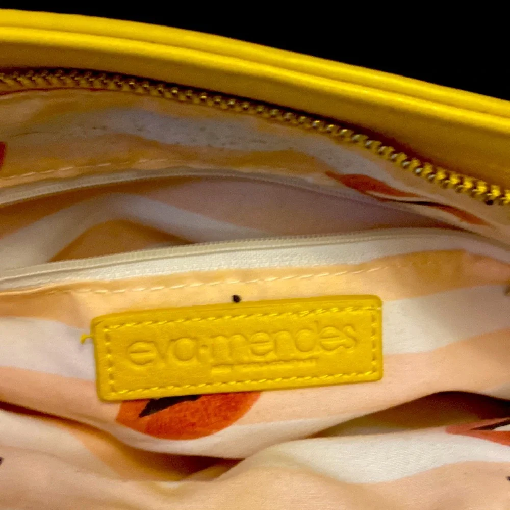 YELLOW EVA MENDES NEW YORK & COMPANY HANDBAG. It has 2 dividers with zippers.